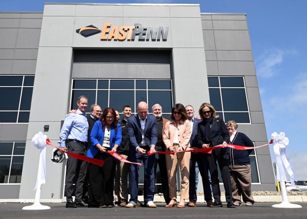 From left, Kathleen Miller, director of the project management office at East Penn Manufacturing; Adonis Illiano, director of distribution operations for East Penn; Christy Weeber, president of East Penn; and U.S. Rep. Madeleine Dean cut the ribbon at the East Penn Manufacturing Corporate Distribution Center, 8697 Allentown Pike, Maidencreek Township, on Friday, April 10, 2026. (BILL UHRICH/READING EAGLE)