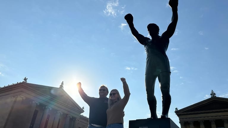Visitors pose in front of the Rocky statue at the...