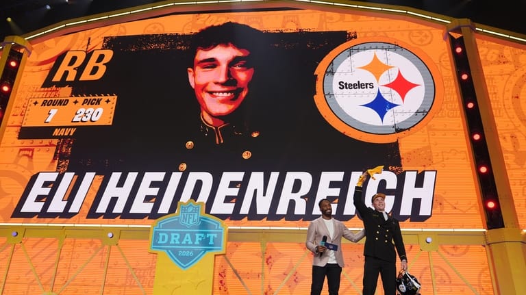 Navy running back Eli Heidenreich celebrates after being chosen by...