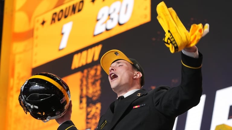 Navy running back Eli Heidenreich celebrates after being chosen by...