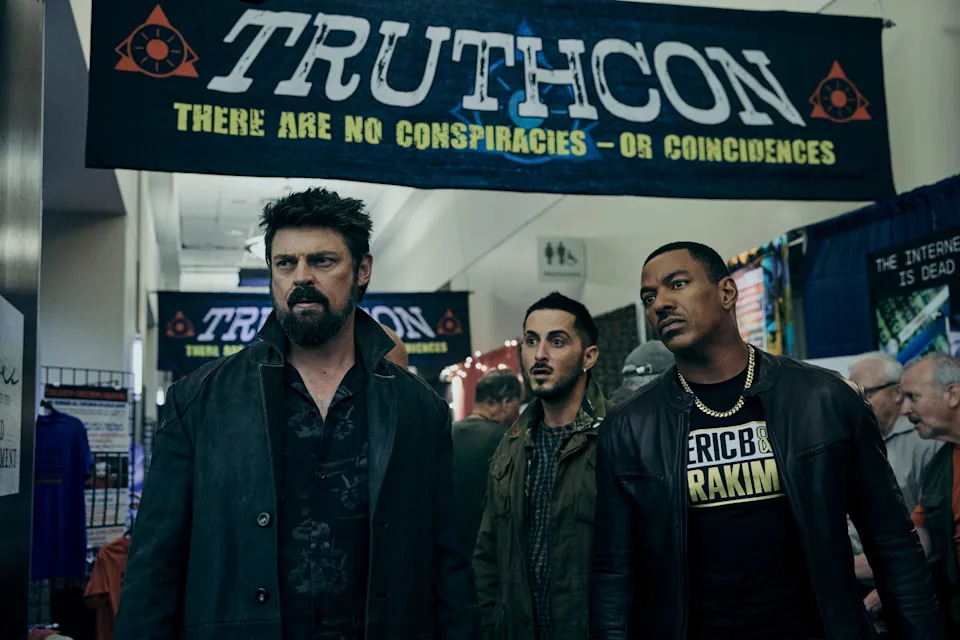 Butcher (Karl Urban, far left), Frenchie (Tomer Capone, center) and M.M. (Laz Alonso) hit up a convention for right-wing conspiracy theorists in an episode from season four of "The Boys."