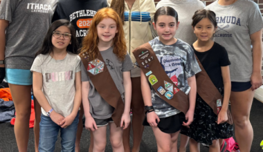 group of Girls Scouts poses for photo with group of high school students