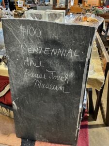 a sign reads $100, CENTENNIAL HALL Please Touch Museum