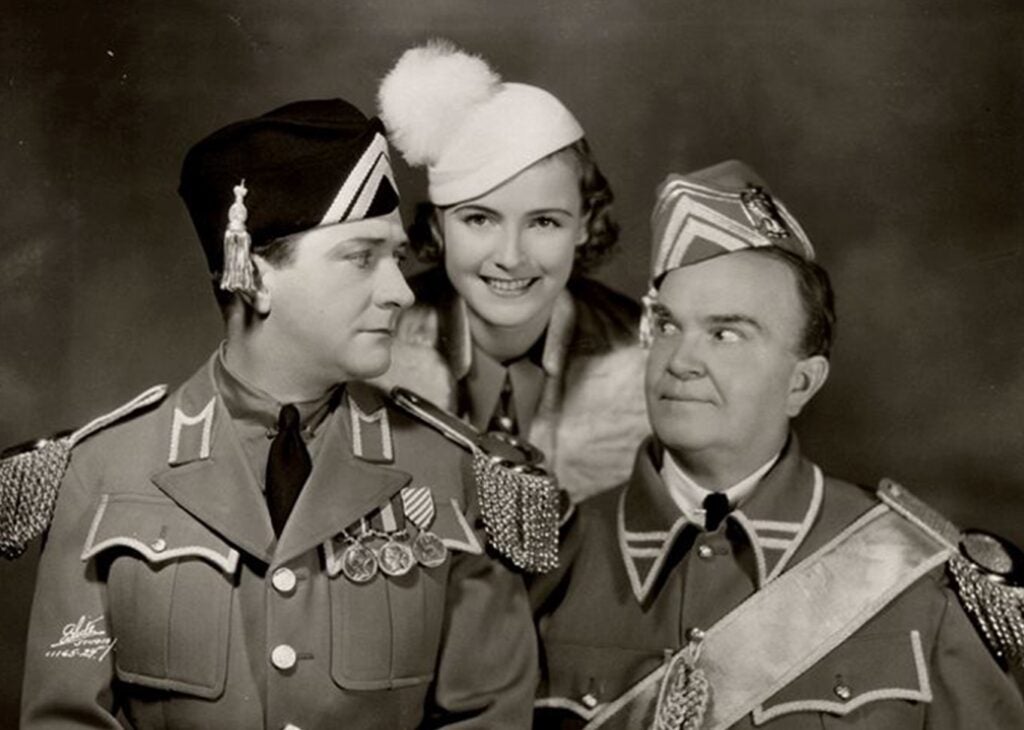 William Gaxton, Lois Moran and Victor Moore posing for a photo wearing their performance clothing