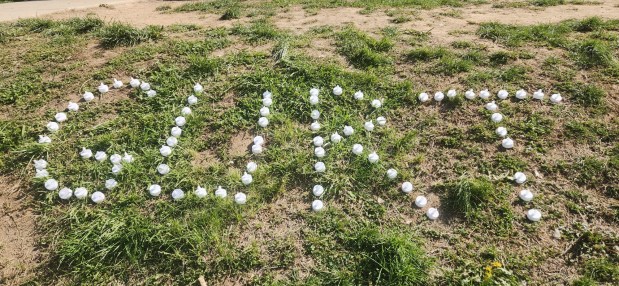 The nickname of student Garrett Nicolas "GURT" who died Sunday morning is displayed in candles outside his frat house. (BILL RETTEW/MEDIANEWSGROUP)
