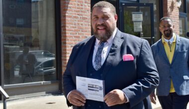 Omar Sabir, chair of the City Commissioners, carries his primary ballot to a dropbox Monday, April 27, 2026, in University City.