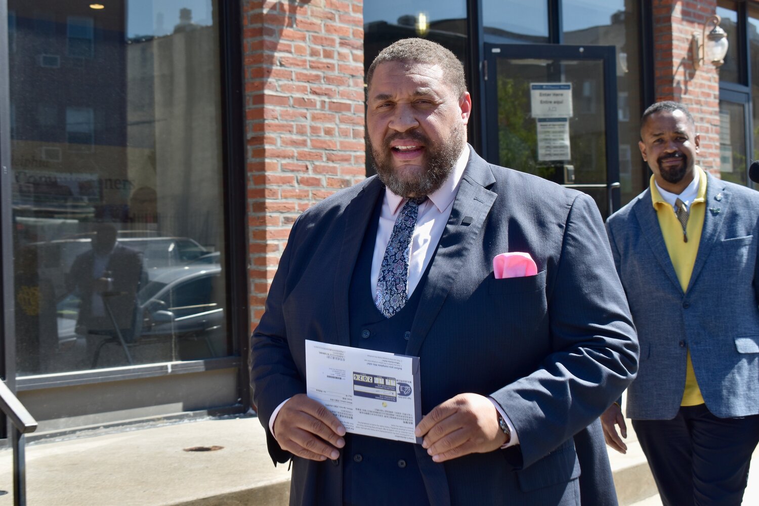 Omar Sabir, chair of the City Commissioners, carries his primary ballot to a dropbox Monday, April 27, 2026, in University City.