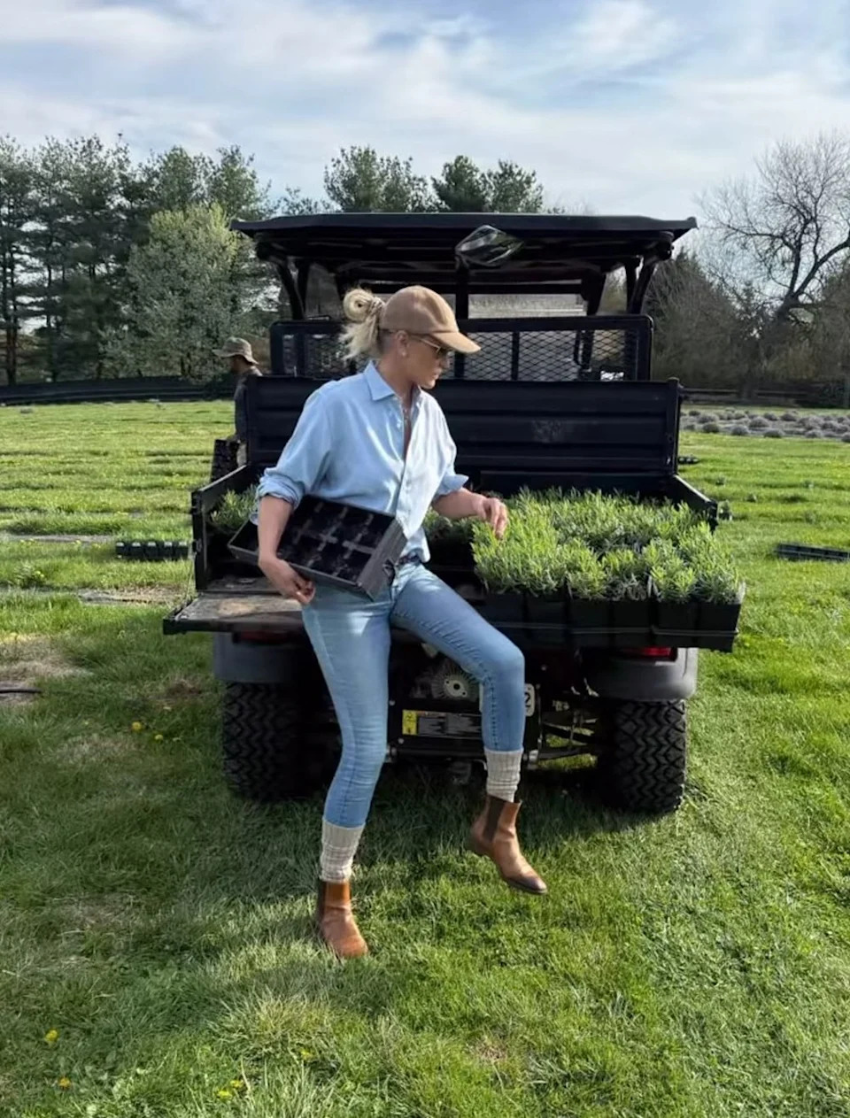 Yolanda Hadid posing with a truck and plants at her farm