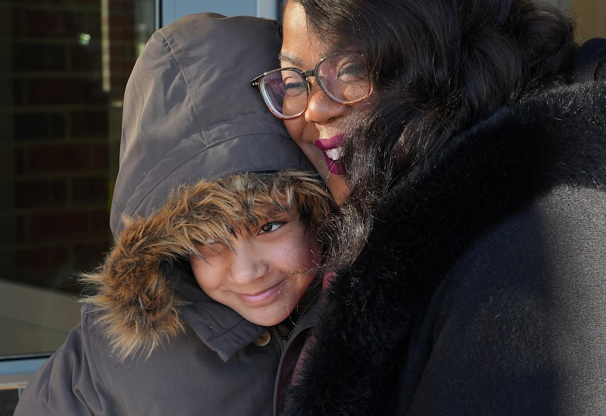 Fourth-grader Lyric Mansfield, 9, gets a hug from Erie school Superintendent Natalyn Gibbs upon entering the new Edison Elementary School on April 8. A week later, the Erie School Board approved a strategic plan for the district's next five years.