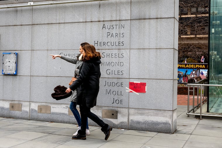 Signs and notes placed by visitors at the President's House in Independence National Historical Park in March. The Trump administration is bent on rewriting the history of the memorial, writes Sharon Ann Holt.