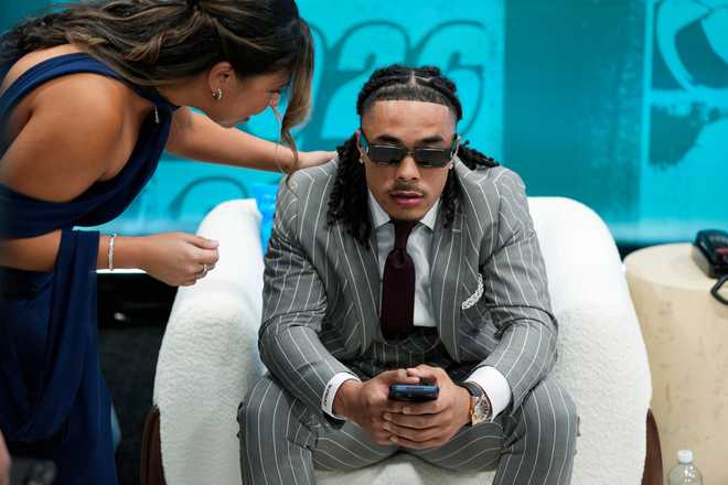 USC wide receiver Makai Lemon reacts after being chosen 20th overall by the Philadelphia Eagles in the green room during the the first round NFL football draft in Pittsburgh, Thursday, April 23, 2026. (Doug Benc/AP Content Services for the NFL)