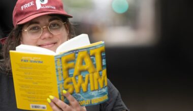 Emma Copley Eisenberg with her book “Fat Swim” near a billboard along Interstate 95 promoting the new release, Monday, April 13, 2026.