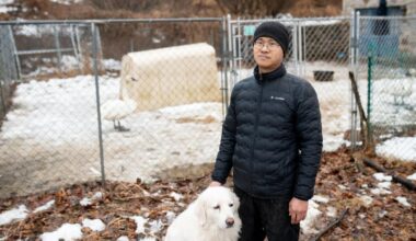 Ge Fangyuan, a farmer in Washington Township, stands with his dog for a portrait at the farm Feb. 20, 2026. Fangyuan's farm was disrupted after a sewer main break dumped about 8,000 gallons of raw sewage in November 2024. - WFMZ.com