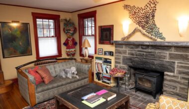 A Narberth psychotherapist has added many artistic touches to her home, including in the living room, where three-dimensional artwork hangs above the mantel, and a costume she made for her daughter is displayed in a corner.