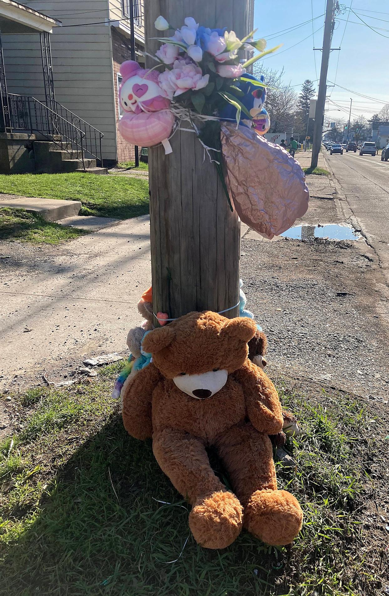 A makeshift memorial of stuffed animals stands near the site of the March 29 house fire at 535½ E. 26th St., in which three young children died.