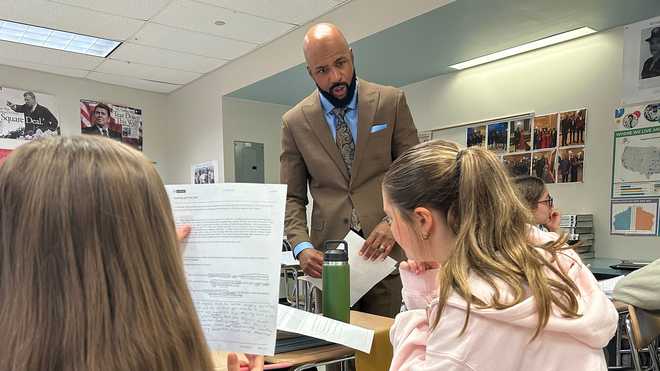 Leon Smith, named the 2026 National Teacher of the Year, talks to students in his classroom at Haverford High School, in Havertown, Pa.on Monday, April 20, 2026. (AP Photo/Tassanee Vejpongsa)