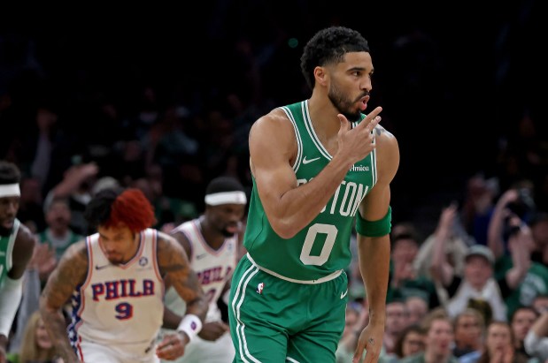 Boston Celtics forward Jayson Tatum (0) celebrates a three as the Celtics take on the 76ers at the garden in game 2 of the first round of the Playoffs. (staff photo by Stuart Cahill/Boston Herald)