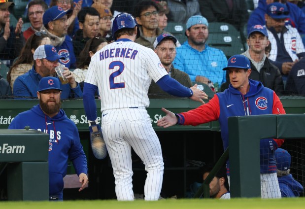 Cubs second baseman Nico Hoerner is congratulated by manager Craig Counsell after scoring on a fielder's choice in the first inning against the Phillies at Wrigley Field on April 22, 2026, in Chicago. (John J. Kim/Chicago Tribune)
