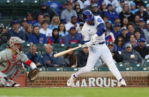 Cubs second baseman Nico Hoerner swings for a single in the first inning against the Phillies at Wrigley Field on April 22, 2026, in Chicago. (John J. Kim/Chicago Tribune)