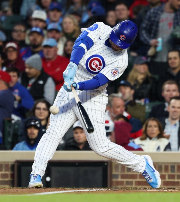 Cubs left fielder Ian Happ swings for an RBI single in the third inning against the Phillies at Wrigley Field on April 22, 2026, in Chicago. (John J. Kim/Chicago Tribune)