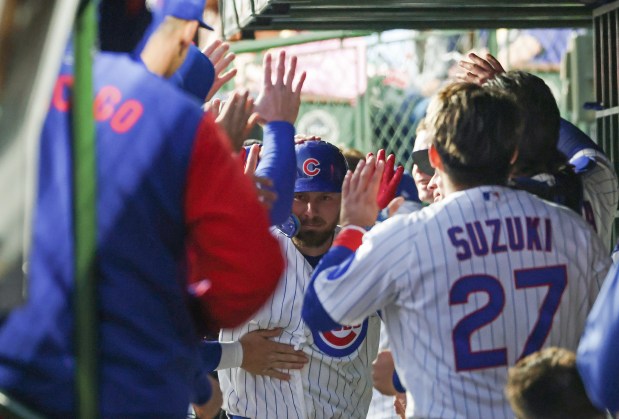 Cubs first baseman Michael Busch, center, is congratulated after hitting a home run in the third inning against the Phillies at Wrigley Field on April 22, 2026, in Chicago. (John J. Kim/Chicago Tribune)