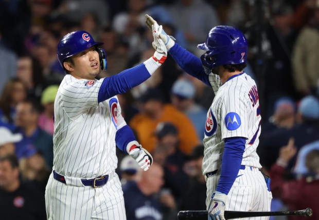 Cubs right fielder Seiya Suzuki, left, is congratulated after hitting a two-run home run in the fifth inning against the Phillies at Wrigley Field on April 22, 2026, in Chicago. (John J. Kim/Chicago Tribune)