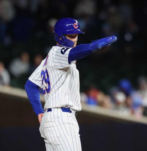 Cubs first baseman Michael Busch motions to teammates while advancing to second base after hitting a single in the fifth inning against the Phillies at Wrigley Field on April 22, 2026, in Chicago. (John J. Kim/Chicago Tribune)