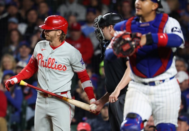 Phillies second baseman Bryson Stott turns away from the home plate umpire after being called out on strikes in the sixth inning against the Cubs at Wrigley Field on April 22, 2026, in Chicago. (John J. Kim/Chicago Tribune)