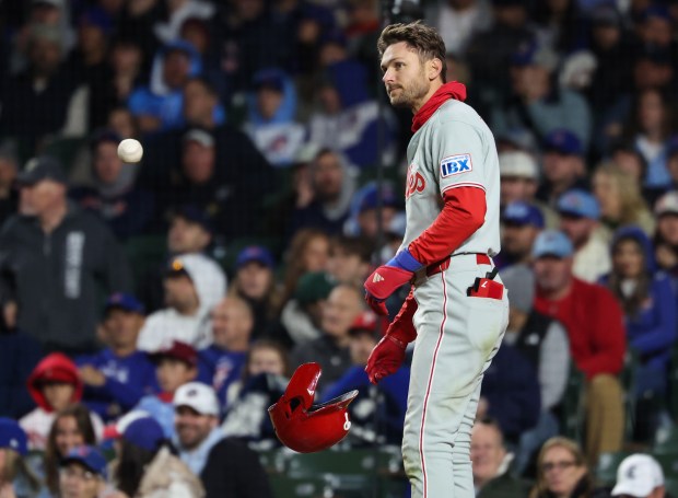 Phillies shortstop Trea Turner drops his batting helmet after striking out in the seventh inning against the Cubs at Wrigley Field on April 22, 2026, in Chicago. (John J. Kim/Chicago Tribune)