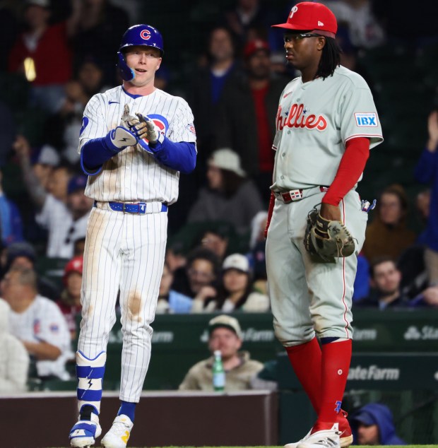 Cubs center fielder Pete Crow-Armstrong, left, gestures to teammates after hitting an RBI single against the Phillies in the eighth inning at Wrigley Field on April 22, 2026, in Chicago. (John J. Kim/Chicago Tribune)