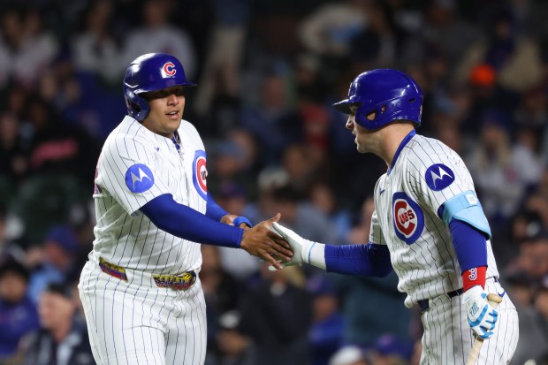 Cubs designated hitter Moisés Ballesteros, left, celebrates after scoring on an RBI single by center fielder Pete Crow-Armstrong in the eighth inning against the Phillies at Wrigley Field on April 22, 2026, in Chicago. (John J. Kim/Chicago Tribune)
