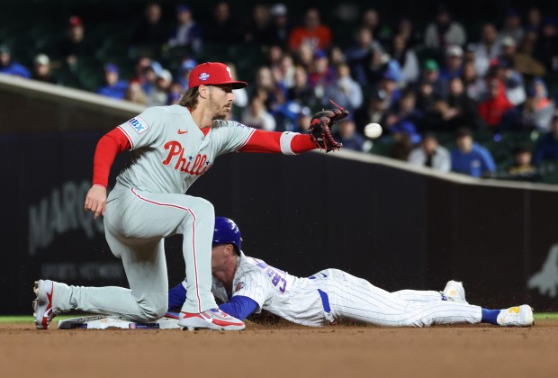 Cubs center fielder Pete Crow-Armstrong beats the throw to Phillies second baseman Bryson Stott to steal second base in the eighth inning at Wrigley Field on April 22, 2026, in Chicago. (John J. Kim/Chicago Tribune)