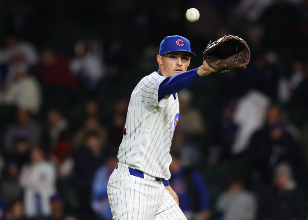 Cubs pitcher Hoby Milner retrieves the ball to throw against the Phillies in the ninth inning at Wrigley Field on April 22, 2026, in Chicago. (John J. Kim/Chicago Tribune)