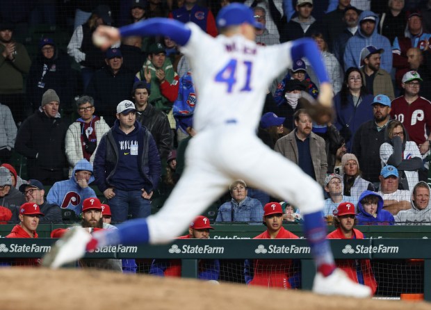 Phillies players and coaches watch their final at-bat before a 7-2 loss to the Cubs at Wrigley Field on April 22, 2026, in Chicago. (John J. Kim/Chicago Tribune)