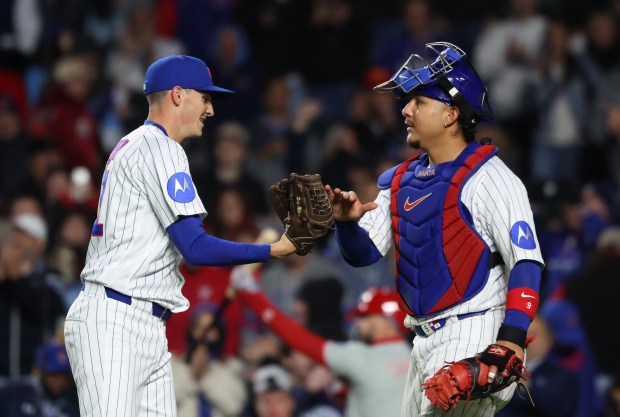 Cubs pitcher Hoby Milner, left, and catcher Miguel Amaya celebrate a 7-2 win over the Phillies at Wrigley Field on April 22, 2026, in Chicago. (John J. Kim/Chicago Tribune)