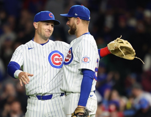 Cubs third baseman Alex Bregman, left, and first baseman Michael Busch celebrate a 7-2 win over the Phillies at Wrigley Field on April 22, 2026, in Chicago. (John J. Kim/Chicago Tribune)