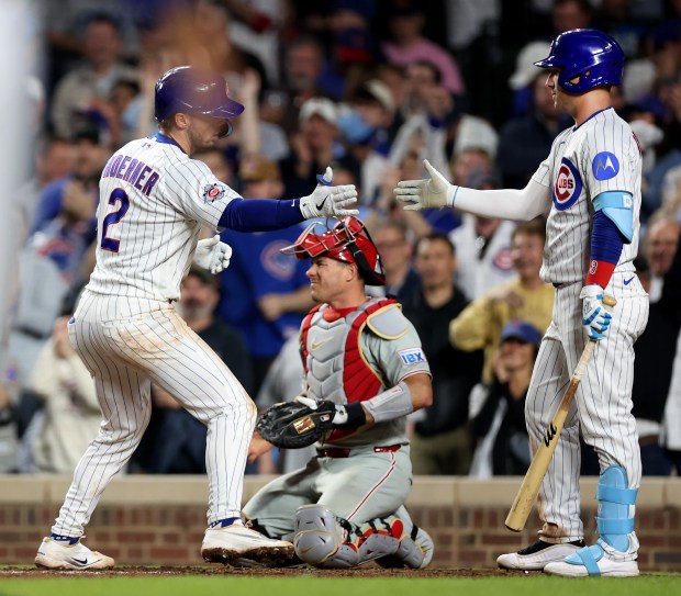 Chicago Cubs second baseman Nico Hoerner (2) is congratulated by teammate Alex Bregman after Hoerner hit a solo home run in the seventh inning of a game against the Philadelphia Phillies at Wrigley Field in Chicago on April 21, 2026. (Chris Sweda/Chicago Tribune)