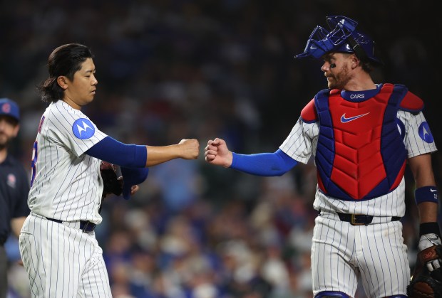 Chicago Cubs starting pitcher Shota Imanaga (left) and catcher Carson Kelly congratulate one another after shutting down the Philadelphia Phillies in the fifth inning of a game at Wrigley Field in Chicago on April 21, 2026. (Chris Sweda/Chicago Tribune)
