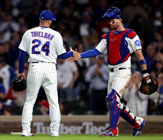 Chicago Cubs relief pitcher Caleb Thielbar (24) and catcher Carson Kelly celebrate after securing a victory by closing out the Philadelphia Phillies in the ninth inning of a game at Wrigley Field in Chicago on April 21, 2026. (Chris Sweda/Chicago Tribune)