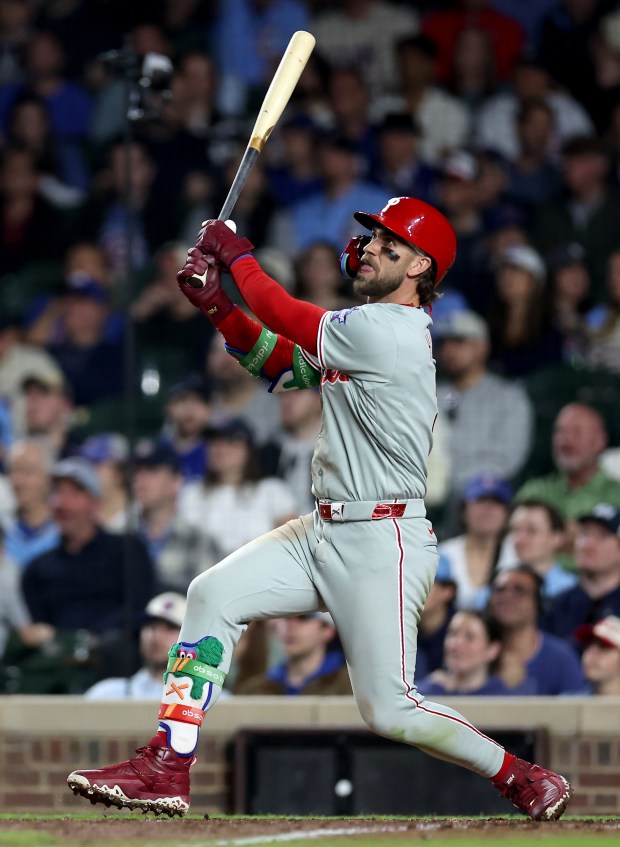 Philadelphia Phillies first baseman Bryce Harper (3) hits a two-run home run in the eighth inning of a game against the Chicago Cubs at Wrigley Field in Chicago on April 21, 2026. (Chris Sweda/Chicago Tribune)