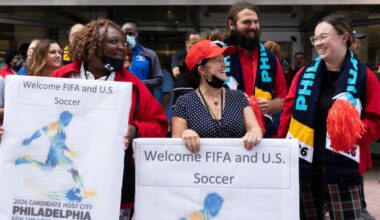 SEPTA employees (from left) Bernadette Foster, Nancy Mazzuca, and Olivia Hopkins attend at a pep rally hosted by the Philadelphia World Cup bid committee to welcome executives from FIFA at 12th and Market on Sept. 22, 2021.