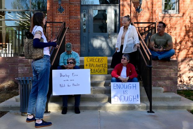 Protesters sit outside the Erie Town Hall leading up to the State of the Town. (Joel Solis/Staff Photographer)
