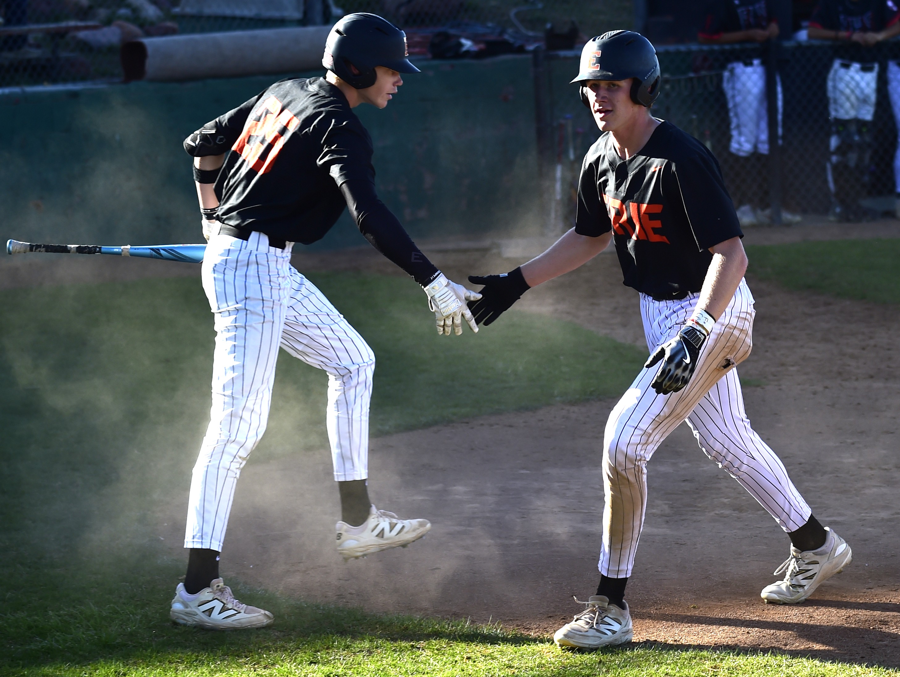 Erie's Boston Coslett (right) celebrates his scored run with Chase...