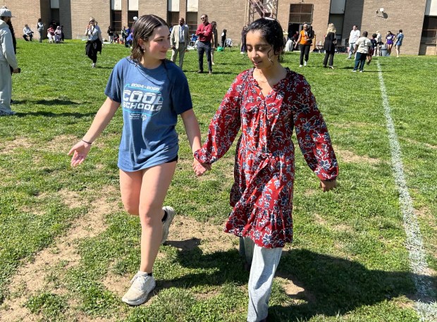 Softball senior Gabby Johnston, left, and Fatima head for the April Shower. (PETE BANNAN-DAILY TIMES)