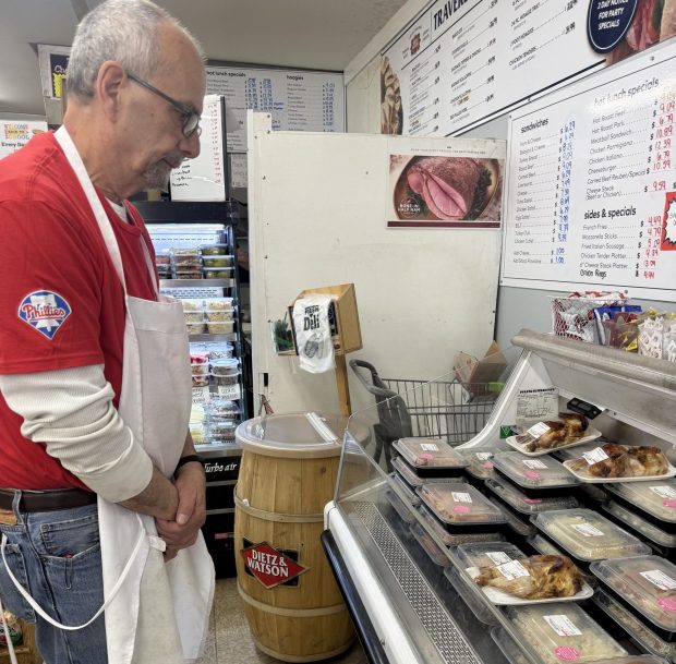 David Travers with the display case of grab-and-go meals that are freshly prepared for customers each day. (PEG DEGRASSA - DAILY TIMES