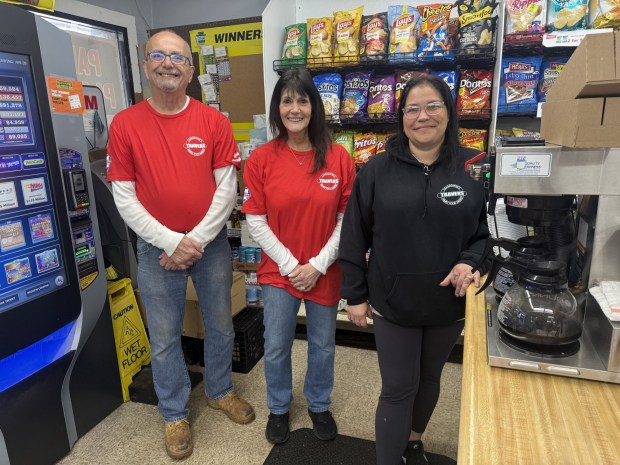 Travers Food Market owners David and Donna Travers with longtime employee Gina Herm of West Chester, who was a frequent customer of the store when she was a young girl living in Lansdowne. She has worked there for over 25 years. (PEG DEGRASSA - DAILY TIMES)