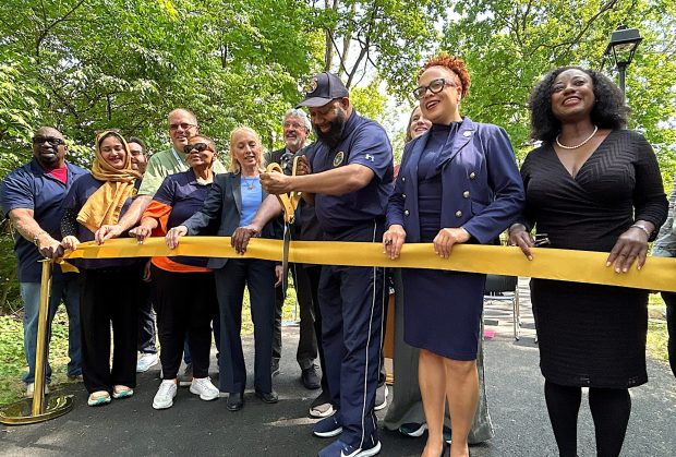 Upper Darby Mayor Ed Brown cuts the ribbon Friday officially opening Section 5A of Naylor's Run Trail, which joins Garrett Road to Marshall Road. With him are officials holding township, state and federal offices. (PETE BANNAN-DAILY TIMES)