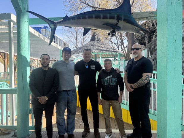 Standing inside the new Baja Beach Club Philadelphia, underneath a mounted hanging marlin, are, left to right, General Manager Michael Avery, Club COO Tyler McKee, co-owner/ CEO Bill McKee, co-owner/president Bryan McDonaugh, and Ian Strassler of Advantage Security Company. Owner Bill McKee caught the 14-foot long marlin, 269 pounds, during a Y100 Baja vacation in Los Cabos, Mexico in 1995. (PEG DEGRASSA/ DAILY TIMES)