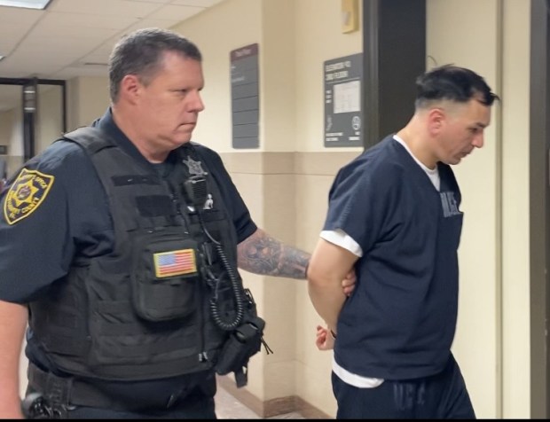 Miguel Guzman-Pardo is escorted by a deputy sheriff from a Montgomery County courtroom to begin prison term. (Photo by Carl Hessler Jr. - MediaNews Group)