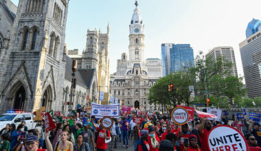People march near Philadelphia City Hall during the "For the Workers, Not the Billionaires May Day Rally" in Philadelphia, Pennsylvania on May 1, 2025. US Senator Bernie Sanders addressed the protesters who marched and participated in an act of civil disobedience.